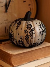 a white pumpkin covered with black lace is a pretty decoration for fall or Thanksgiving