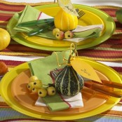 a bright Thanksgiving tablescape with berries and mini gourds, bright striped table runners and mini veggies