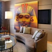 a TV on the wall hidden with a large Egypt-inspired panel for a unique and quirky look in the living room