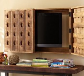a TV hidden with two wooden doors with perforations is a creative decor idea for a rustic or farmhouse interior