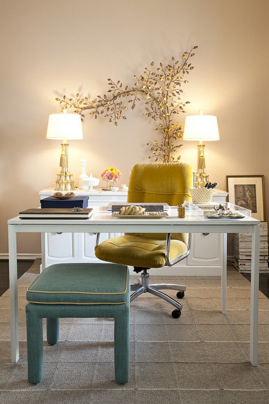 a beautiful and chic neutral home office with a sleek white desk, a yellow chair, a mint green stool, a white console table and a unique gold branch decoration on the wall