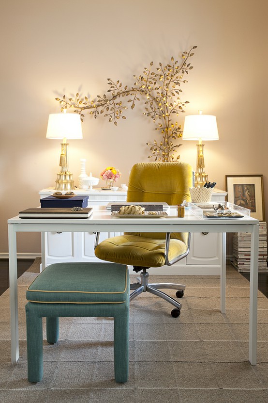 a beautiful and chic neutral home office with a sleek white desk, a yellow chair, a mint green stool, a white console table and a unique gold branch decoration on the wall