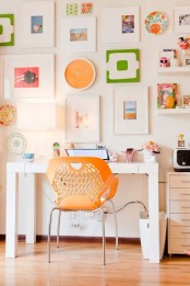 a neutral home office made brighter with some colorful items – an orange chair, bright artwork and books plus some blooms feels inspiring and pretty