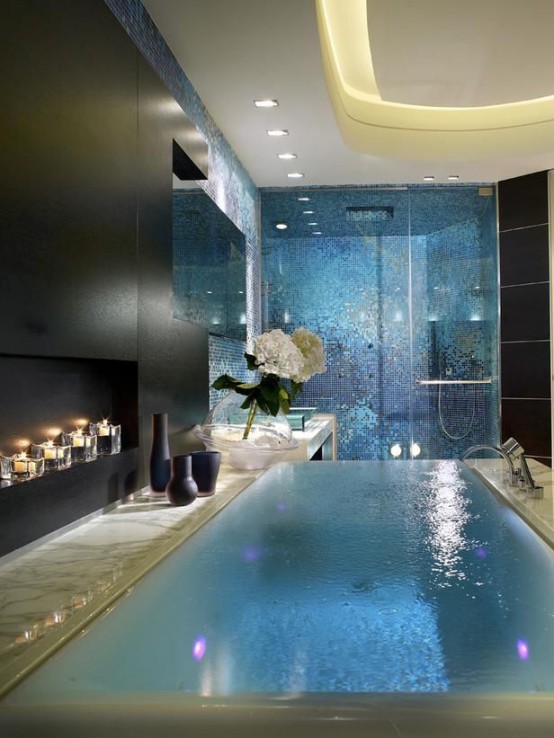 a refined contemporary bathroom with black walls and a white ceiling with built-in lights, a shower space clad with blue tiles, a large hot tub is amazing