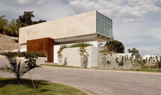 House Composed by Two Rectangular Prisms on a Sloped Site
