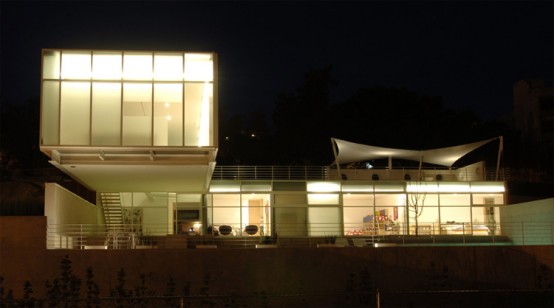 House Composed By Two Rectangular Prisms On A Sloped Site