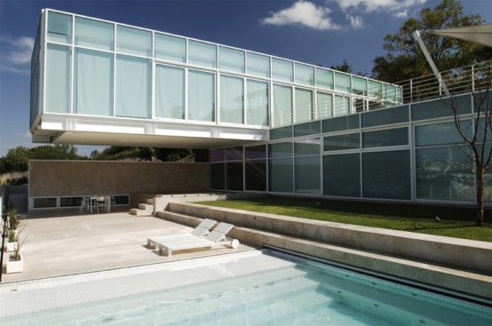 House Composed By Two Rectangular Prisms On A Sloped Site