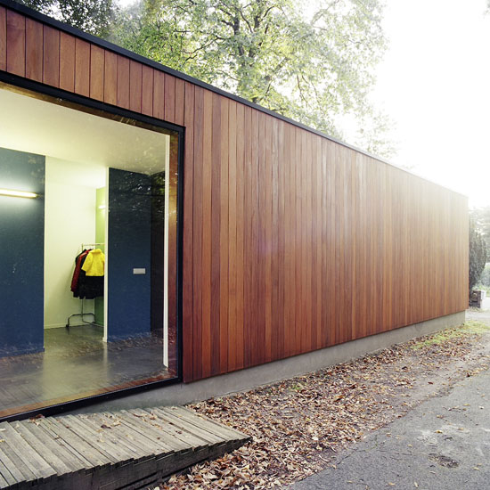 House With Large Glazing And Very Old Pine Tree On Site