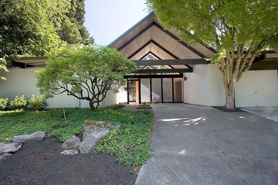 House Wrapped Around the Open Atrium with High Double Gables