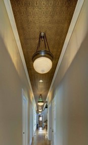 a beautiful and refined tin tile ceiling and large pendant lamps is a lovely solution for a long corridor