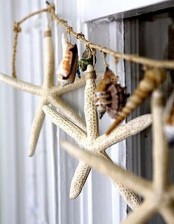 a catchy twine and seashell and starfish garland can be hung anywhere – on the window, on a shelf or wherever else you want