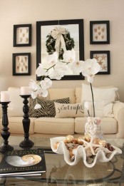 a gorgeous centerpiece with a white orchid and a large seashell with smaller ones and starfish is a chic idea for your home