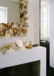 seashells and starfish on the mantel and covering the mirror frame make the space feel coastal and sea-inspired at the same time