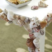 an outdoor table decorated with real seashells is ideal for a coastal or seaside outdoor space or just if you love the sea