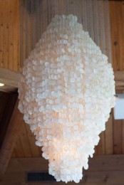 an oversized chandelier of seashells will easily turn your home into a gorgeous seaside space and it will match a boho space, too