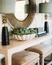 a white bowl with succulents and some dried blooms is a pretty and eye-catchy decoration to rock