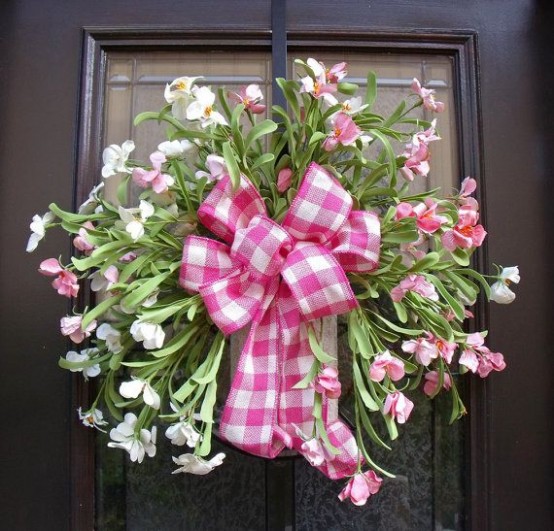 a fresh pink bloom wreath with a pink plaid bow is a bold summer-like decoraiton for your front door