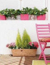 a plywood box with greenery and pink blooms is a cool summer decoration for outdoors or for a farmhouse space