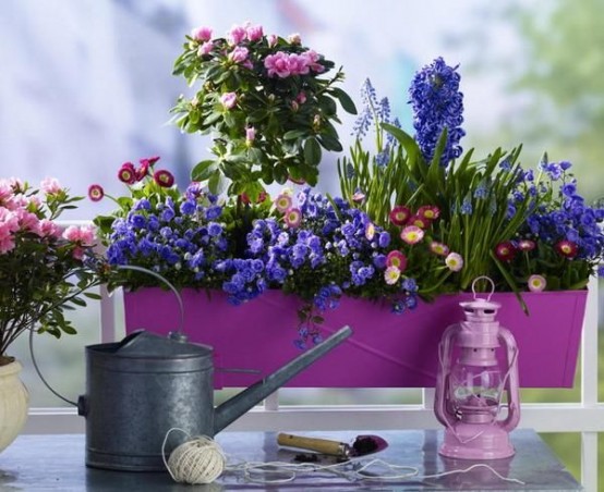 a purple metal planter with bright blooms is a cool summer decoration for indoors and outdoors with a vintage feel