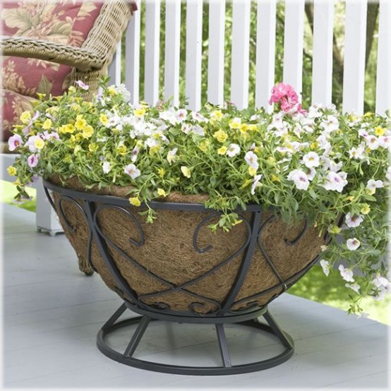 an oversized turf planter with lots of colorful blooms will make your outdoor space more elegant and summery