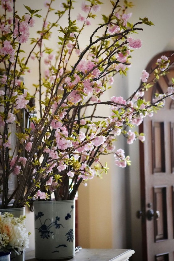vintage vases with blooming cherry branches are always a good idea for every space, both indoor and outdoor