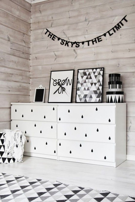 a simple and cute IKEA Malm hack with black raindrop decals on the drawers is a cute idea for a Nordic nursery
