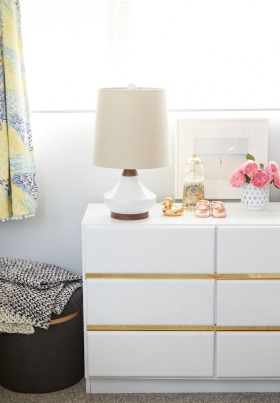 an IKEA Malm hack with upholstered drawers and gold contact paper for a contemporary space