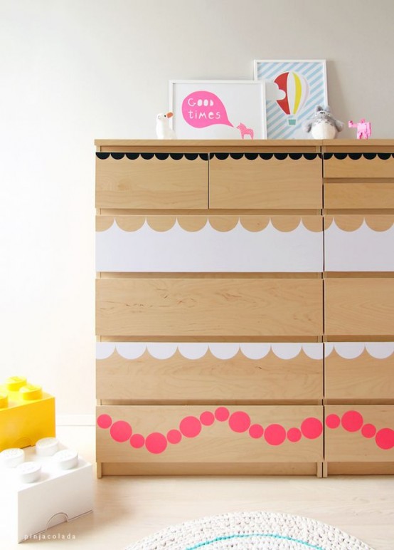 a light-stained IKEA Malm dresser hacked with simple white and pink decals on the drawers