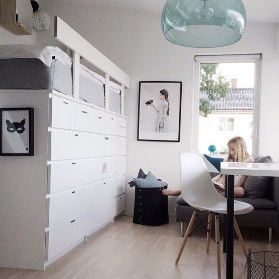 a whole storage wall built of IKEA Malm dressers lets your store a lot of things without cluttering the space