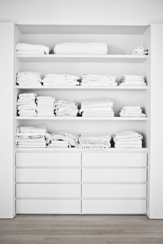 a built-in closet with open shelving and IKEA Malm dressers for smaller items is a simple and cool idea