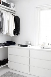 a Nordic closet done with open shelving, racks and IKEA Malm dressers