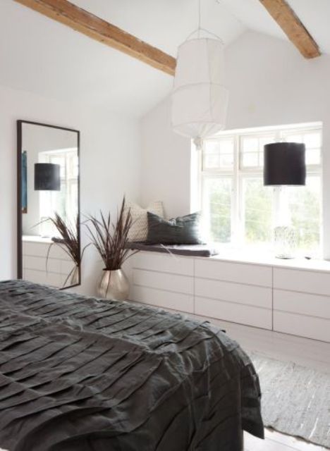 a Scandinavian bedroom with IKEA Malm dressers at the window that will give much storage space