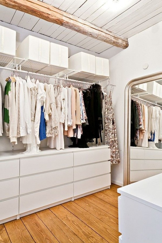 a welcoming and airy closet with open shelving and holders plus some Malm dressers for storage