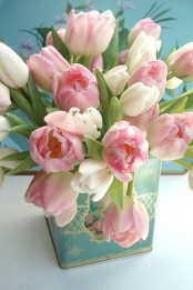 a light blue vintage tea can with pink and white tulips is a pretty vintage-inspired centerpiece