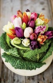 place colorful tulips into a cabbage instead of a usual vase to compose a cute rustic-inspired centerpiece