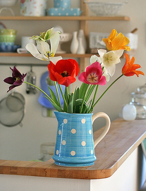 a vintage spring decoration with a blue retro jar and bright tulips is a cool idea thta is easy to compose