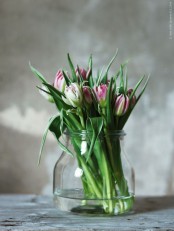 a large jar with pink tulips is a simple spring-like decoration that can be made anytime