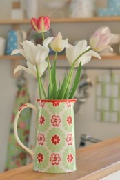 a vintage printed jug with white and pastel tulips is a cool spring or Easter centerpiece or decoration