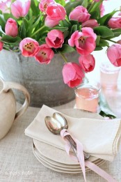 a galvanized bucket with hot pink tulips is a nice centerpiece for any party or a bold decoration for indoors and outdoors