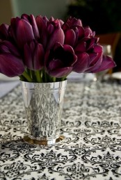 a polished mini bucket with deep purple tulips is a bold and refined spring centerpiece or decoration