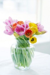 a clear glass vase with colorful spring tulips is a bright spring and Easter centerpiece that embraces the season