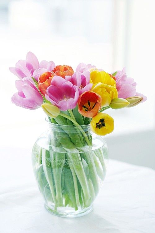 a clear glass vase with colorful spring tulips is a bright spring and Easter centerpiece that embraces the season