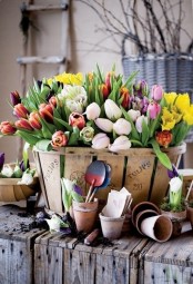 a wooden basket with colorful tulips will be a gorgeous rustic spring decoration for indoors and outdoors, too