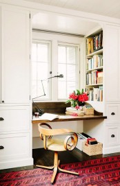 built-in shelving in the sides of the bookshelves are a nice idea to squeeze some storage space into a tiny nook