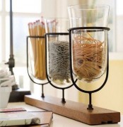 a wooden shelf with glass jars attached – these jars may be used for organizing anything you want