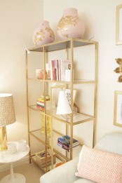 gilded IKEA Hyllis shelves for storing books, lamps, candle holders and oversized vases look very chic and shiny