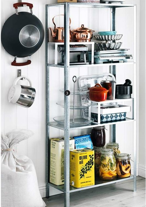 an IKEA Hyllis shelf with various jars, oils, pots, plates and kettles, such a comfy and durable shelf is great for kitchens