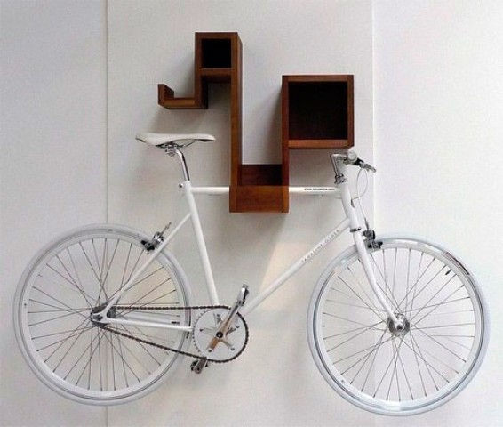 a creative mid century modern wall mounted shelf that holds a bike is a lovely way to store it and display at the same time