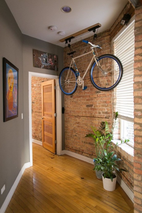a special holder attached to the ceiling and holding a bike is a great idea for any space and it can be placed absolutely anywhere, not only in the corridor