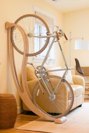 a lovely wall-mounted wooden bike holder is a very chic and elegant idea for any space is a gorgeous idea for a modern space